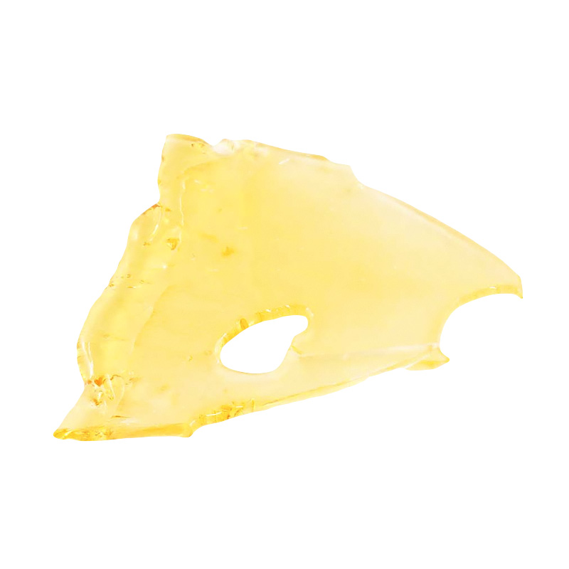 Jet Fuel shatter, a form of cannabis concentrate with yellow-amber hue and glass-like texture on white background.