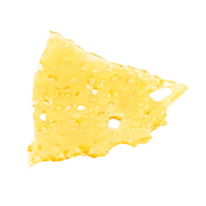 Lemon Haze shatter, a form of cannabis concentrate with yellow-amber hue and glass-like texture on white background.